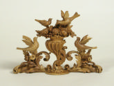Miniature carved basswood crest depicting four birds and foliage decoration