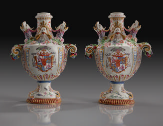 Two white porcelain armorial potpourri vases with dragon heads
