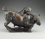 Bronze sculpture of a leopard attacking a bull.  The leopard is actively clawing and biting the…
