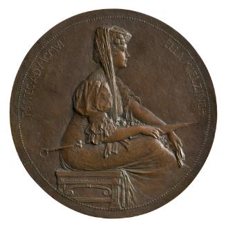 Bronze portrait medal of Ella Mielziner seated on a bench, with hair worn pinned beneath a pill…