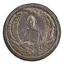 Silver portrait medal of Sir William Parkhurst framed by an ornate border of scrolls, bouquets …