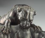 Alternate view of a bronze sculpture of a leopard attacking a bull.  The leopard is actively cl…