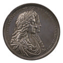 Silver portrait medal of King James II with a laurel wreath in his long, curling hair, wearing …