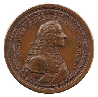 Bronze medal of a man in profile to the right with inscription