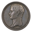 Silver medal of a man in profile to the left with short hair
