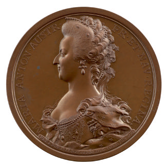 Bronze medal of a woman in profile to the left