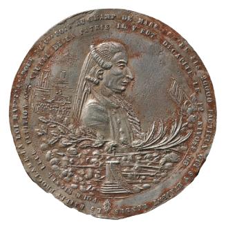 Tin medal of a man in profile to the right, below him branches of oak and palm above a pile of …