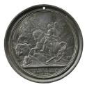 Lead medal depicting Napoleon on horseback, wearing military uniform and a commander’s cape, ri…