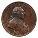 Bronze medal of a man in profile to the right wearing a lace cravat, a jacket with brocaded bor…