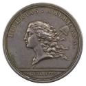 Silver medal depicting the figure of Liberty with her long hair blowing in the wind and the Phr…