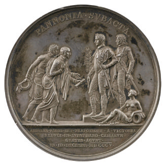 Silver medal of two men bowing, one presenting a scroll to two standing figures