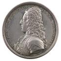 Silver medal of a man in profile to the left in a periwig tied with a ribbon, wearing a silk cr…