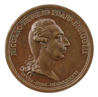 Bronze medal of a man in profile to the right