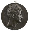 Bronze medal of a man in profile to the right