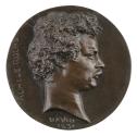 Bronze medal of a man in profile to the right