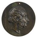 Bronze medal of a man in profile to the right