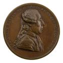 Bronze medal of a man in profile to the right wearing a periwig