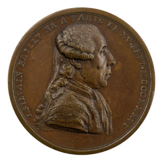 Bronze medal of a man in profile to the right wearing a periwig
