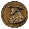 Bronze medal of a man wearing a wide-brimmed hat and a fur-collared mantel