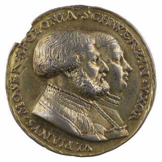 Silver medal of man and woman both in profile to the right
