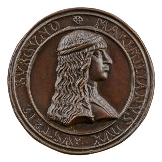 Copper medal of a man in profile to the right with long hair and a headband