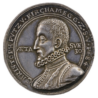 Silver medal of a man in profile to the left wearing a doublet and ruff