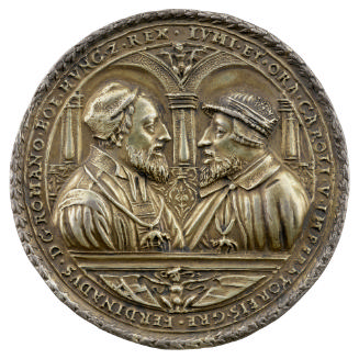 Silver medal depicting Charles V on the left and Ferdinand I on the right; both wearing hats an…