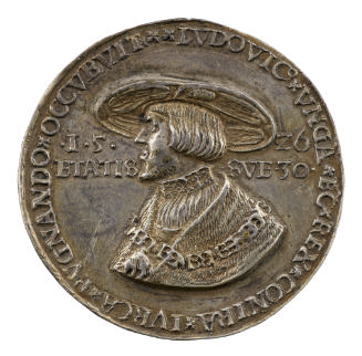 Silver medal of a man wearing a large-rimmed hat, a pleated chemise with embroidered collar, a …