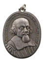 Silver medal of balding man with a mustache and beard, facing three quarters to the right