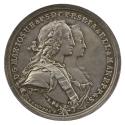 Silver medal of a man and woman in profile to the right