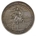 Silver medal depicting a man on a rearing steed in front of troops and a walled cityscape