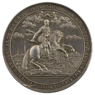 Silver medal depicting a man holding a baton on horseback and moving to the right and turning t…