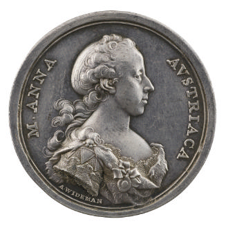 Silver medal of a woman wearing a dress with a fur collar
