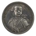 Silver medal of a boy turned three-quarters facing front, wearing a wig and fur mantle