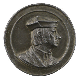 Lead medal of man in profile to the right wearing fur coat and hat