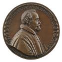 Bronze medal of a man in profile to the right