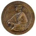 Bronze medal of a man wearing a hat, a pleated shirt, a rich cape, and a chain and holding a ro…