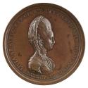 Bronze medal of a woman in profile to the right with hair styled high and draped