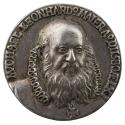 Silver medal of a balding man with mustache and beard, facing three quarters to the right and w…