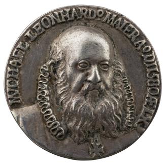 Silver medal of a balding man with mustache and beard, facing three quarters to the right and w…