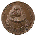 Bronze medal of a man wearing a skullcap, ruff, and ecclesiastical gown