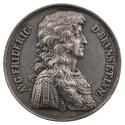 Silver medal of a man wearing a wig in profile to the right