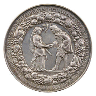 Silver medal of a man and woman holding hands, between whom a dove descends with an olive branc…