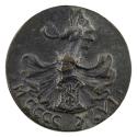 Bronze medal of a shield with an “S” on it, surmounted by a helmet surrounded by drapery, with …