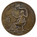 Bronze medal of a woman seated in a chair, nude from the waist up, holding a cornucopia in her …