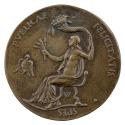 Bronze medal of a woman seated in a chair, nude from the waist up, holding a cornucopia in her …