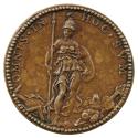 Bronze medal of a woman wearing a loose classical robe and a plumed helmet, holding a spear in …