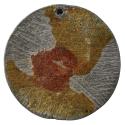 Unmarked lead medal with a scratched surface with orange and red stains over most of the surfac…