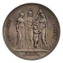 Silver medal of three woman (possibly goddesses) standing around a nude boy. The woman on the l…