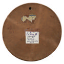 Backside of terracotta medal with label